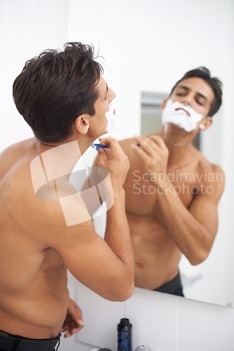 Image of Man, shaving cream and blade in mirror for hair removal in bathroom, beauty and wellness. Male person, skincare and cosmetics or cleaning in morning routine, grooming and razor in reflection at home