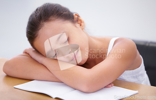 Image of Child, sleeping or tired student in classroom with burnout, dream or low energy for homework. Happy girl, school or exhausted female kid bored by books with fatigue, education or adhd in a lazy nap