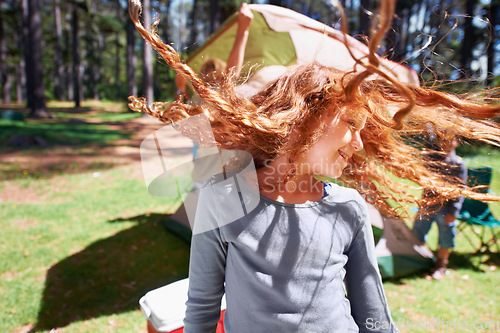 Image of Happy girl, dancing or camping in park to celebrate freedom on fun outdoor holiday vacation in summer. Woods, playful or excited children with smile for twirling hair or wellness in nature or forest