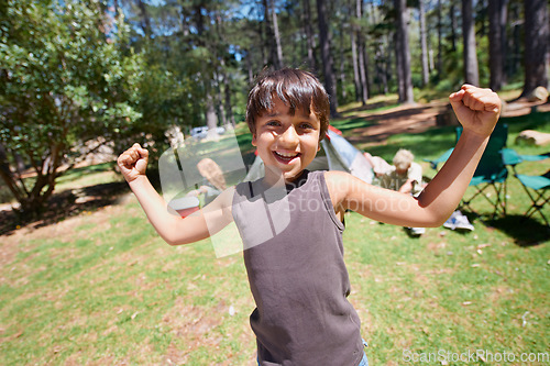 Image of Boy child, flexing outdoor in portrait and fun at summer camp, happiness and celebration with smile. Kid in nature, adventure with winner or champion, playful youth camper in forest and freedom