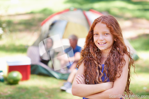 Image of Girl, child and arms crossed, smile at summer camp and nature with fun outdoor for youth in portrait. Kid at campsite in park for adventure and vacation, childhood and recreation with happiness
