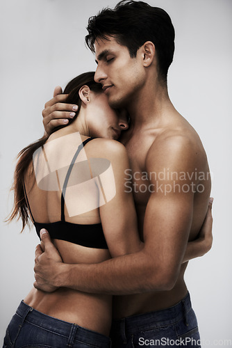 Image of Couple, body and hug with skin in studio, topless and sensual with tender moment on white background. People together for fashion or beauty with intimacy, wellness and embrace, love and romance