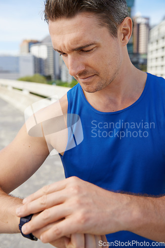 Image of Man, fitness and checking watch in city for workout, exercise or monitoring outdoor performance. Closeup of male person or athlete looking at wristwatch for training or heart rate in an urban town