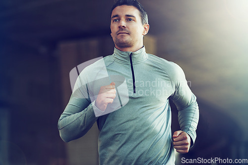 Image of Man, fitness and running for cardio workout, exercise or training with lens flare at the gym. Active male person, runner or athlete for weight loss, health and wellness in fitness on mockup space