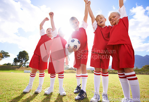 Image of Children, soccer team and celebration for winning or victory, happy and success in outdoors. People, kids and fist pump for achievement, collaboration and partnership or teamwork on field or sport