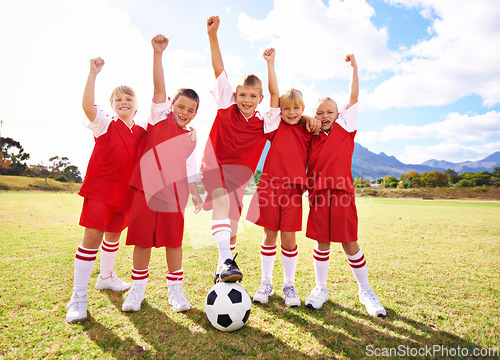 Image of Children, soccer team and celebration for winning or success, happy and victory in outdoors. People, kids and fist pump for achievement, collaboration and partnership or teamwork on field or sport