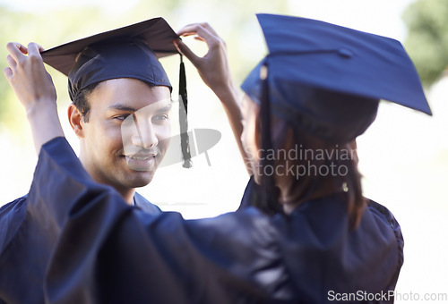 Image of Couple, graduate and woman fix man graduation cap, education and academic success with ceremony. Certification, achievement and event at university with people together for milestone and award
