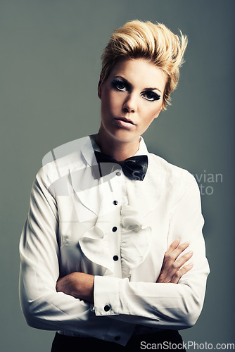 Image of Portrait, bow tie and woman with fashion, vintage clothes and classy aesthetic on grey background. Arms crossed, edgy fashionable model or cool girl with retro style and makeup isolated in studio