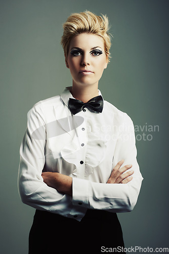 Image of Portrait, bow tie or woman with fashion, vintage clothes and arms crossed on grey background. Classy aesthetic, edgy female model or confident girl with retro style and cool makeup isolated in studio