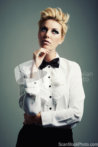 Image of Thinking, bow tie or person with fashion, ideas or vintage clothes on grey background in studio. Classy aesthetic, edgy model or confident woman isolated with retro style, beauty and cool makeup