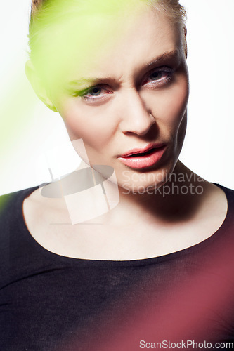 Image of Face, woman and beauty with light streak, confused or frown, creativity glow and skin on white background. Neon color, bright or shine with headshot, makeup and art deco, model with doubt in studio