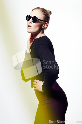 Image of Woman, sunglasses for fashion and light streak, cosmetics or makeup with creativity and neon glow on white background. Art deco, beauty and bright color in studio, glamour and dark eyewear with style