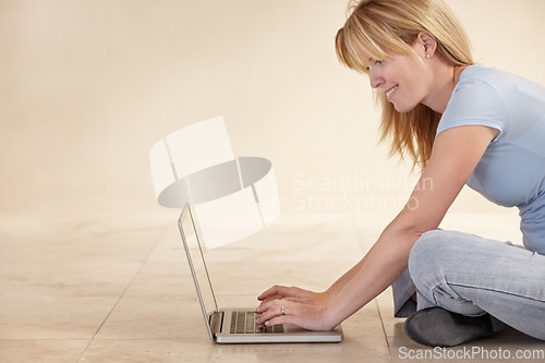 Image of Woman, remote work from home and laptop on floor, smiling and type email for job, copywriter or creative. Freelancer, technology and working for startup publishing company, internet and online