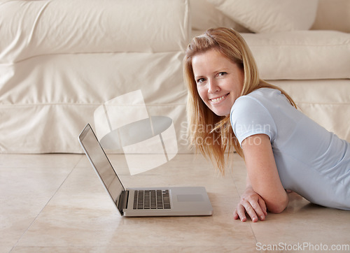 Image of Woman, work from home and laptop on floor, portrait and type email for job, copywriter and creative. Freelancer, technology and working for startup publishing company, internet and happiness