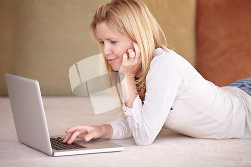 Image of Woman, remote work from home and laptop on floor, smiling and type email for job, copywriter or creative. Freelancer, technology and working for startup publishing company, internet or online worker