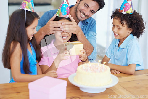 Image of Birthday cake, child and gift with covered eyes, surprise and happy family for celebration, siblings and home. Singing, smile and love with presents, together and parent for childhood, party or kid