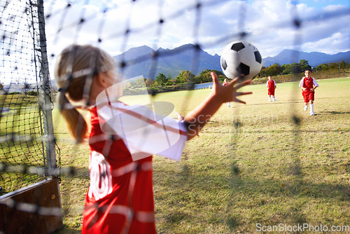 Image of Girl, soccer and ball with goal keeper for save, match or game from scoring point on outdoor field. Team of football players playing together for sports, competition or training practice in nature