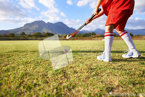 Image of Person, green grass and playing hockey for game, outdoor match or sports in nature for practice. Closeup of child, kid or player enjoying competition with ball on field for fitness training outside