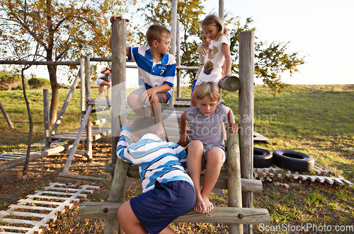 Image of Children, friends and playing at park together on jungle gym for fun weekend, holiday or summer break in nature. Group of young kids or teens enjoying day at outdoor playground for game or activity