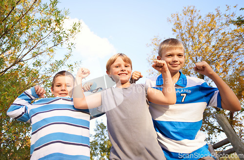 Image of Happy children, portrait and flexing muscles at park for fun day, holiday or weekend together in nature. Face of young kids or friends smile for outdoor summer break, bonding or youth on playground