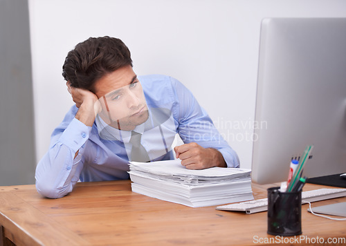 Image of Business man, burnout and fatigue with paperwork, paralegal in office and stress about job. Overworked, bored and tired employee at desk with documents, exhausted and not interested in work