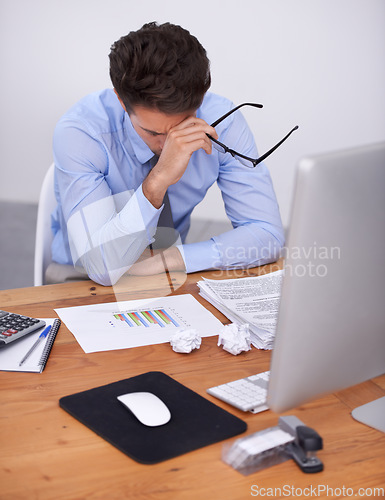 Image of Business man, burnout and headache with graphs at desk, data analyst in office with vision problem and overworked. Anxiety, depression and fatigue, crisis or disaster with analytics deadline and pain