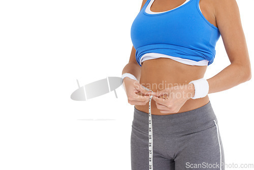 Image of Woman, stomach and measure tape for diet, weight loss and health results or fitness progress in studio. Model hands check body or abdomen for exercise goals, training or workout on a white background