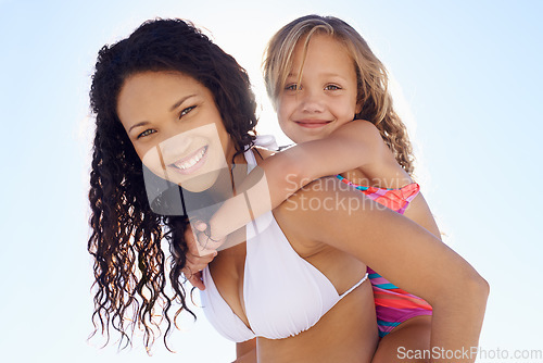 Image of Happy mother, child and piggyback in sun at beach for bonding, vacation or outdoor holiday weekend together. Portrait of mom, kid or daughter smile for love, support or summer on blue sky background