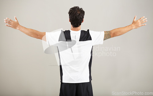 Image of Back, athlete or man for fitness results, wellness and health isolated on grey background in studio. Arms out, model or male person with progress in exercise, workout and training on a backdrop alone