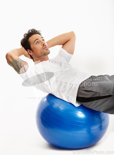 Image of Ball, sit ups or man in studio training abdominal muscles for strong stomach in exercise for fitness. Abs, white background or healthy sports athlete in calisthenics for core, fitness or body workout