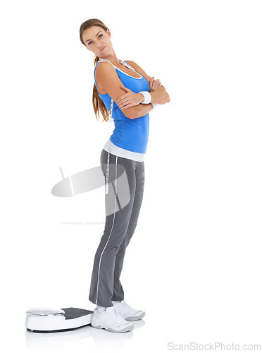 Image of Young woman, portrait and scale for fitness, weight loss or diet on a white studio background. Female person with arms crossed standing in confidence for workout, exercise or training on mockup space