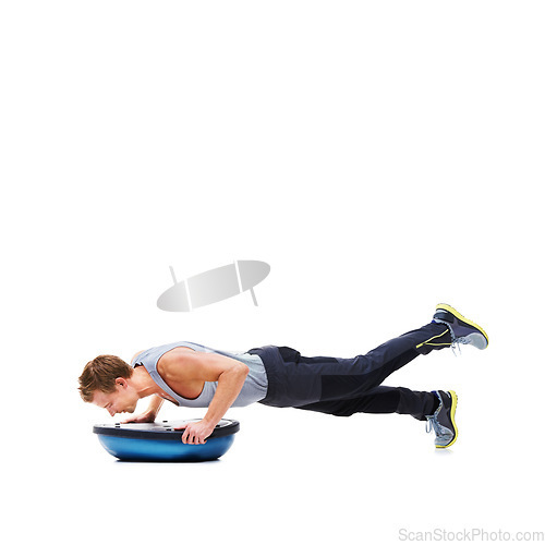 Image of Man, training and push ups with bosu ball for fitness, exercise or workout on a white studio background. Active male person lifting body weight for strength, muscle or strong arms on mockup space