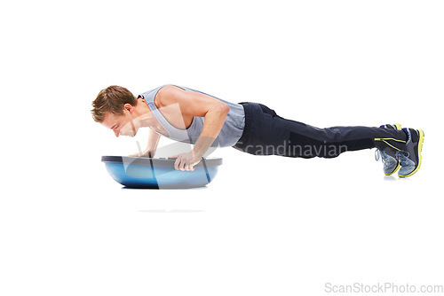 Image of Man, workout and half ball for plank in studio for fitness, strong exercise and gym with muscle health on floor. Bodybuilder or young sports model with push up or arms training on a white background