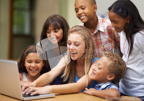 Image of Children, typing on computer and learning in classroom for education, teaching and website information or group project. Happy diversity kids, students and girl with leadership on laptop at school