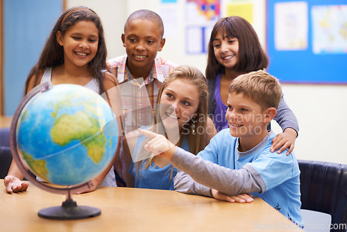 Image of Students, children with globe and learning map in classroom for education, teaching and quiz or group support. Happy kids with planet earth, world and geography for 3d knowledge of history in school