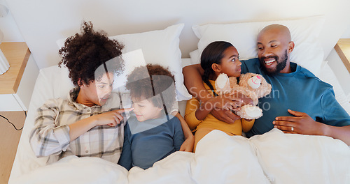 Image of Happy, relax and children with parents in bed of home for bonding together with teddy bear and top. Smile, fun and young interracial man and woman laying for rest with kids in bedroom of family house