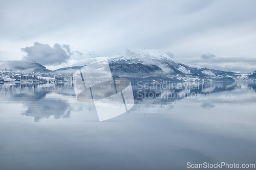 Image of Serene Winter Landscape of Snow-Capped Mountain Reflected in Cal