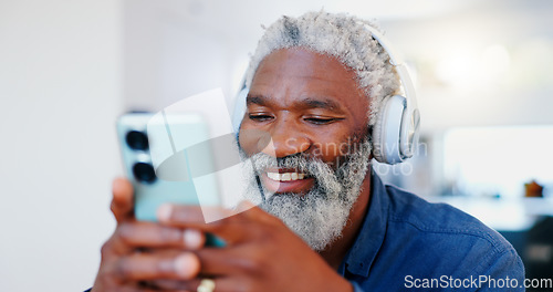 Image of Senior black man, headphones and phone in music or audio streaming, communication or networking at home. Face of mature and happy African male person with smile listening on mobile smartphone headset