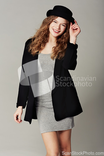 Image of Vintage, fashion and happy portrait of woman with style or aesthetic in grey background of studio. Confident, smile and girl with pride in unique or retro clothing with model in hat for trendy outfit