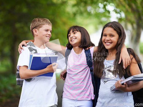Image of Happy kids, friends and hug walking with backpack in park for unity, teamwork or school together. Group of young people smile in nature with bag and books for learning or education in outdoor forest