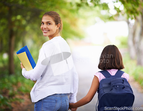 Image of Happy woman, teacher and walking student to school in park or outdoor forest for support or responsibility. Female person, educator smile and holding hands with learner, kid or young child in nature