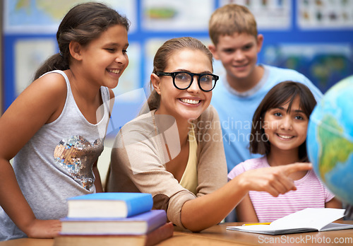 Image of Happy teacher, portrait and students with globe of planet earth in class for education or learning at school. Woman, mentor or educator smile with young kids or children with world map in classroom