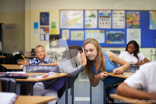 Image of High school, friends and students whispering in classroom for secret, gossip or chatting in lesson. Listening, girls or sneaky female learners sharing quiet message or information secretly in ear