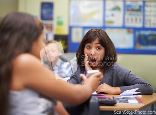 Image of High school, surprise or girl with a phone for a secret, gossip or rude message online in classroom. Show news, share or shocked children with picture on mobile app or social media for cyber bullying