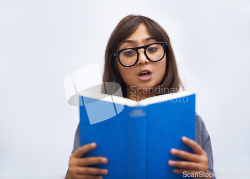 Image of Child, book and reading for development in education, information and knowledge by white background. Girl, student and learning or studying in studio, academy and notebook for story and growth