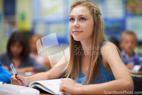 Image of School, girl or thinking with book in classroom lesson for learning, development or education. Studying, scholarship or female learner sitting for exam or test with notes, dream or vision of future