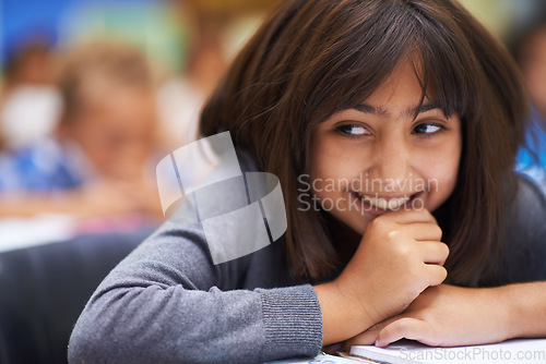 Image of Girl, education and happy in classroom for knowledge, information and notes for learning in school. Female person, book and confidence for assessment or test, studying lesson and smiling at academy