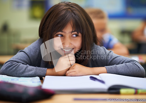 Image of Girl, education and happy in classroom for learning, information and notes for knowledge in school. Female person, book and confidence for assessment or test, studying lesson and smiling at academy