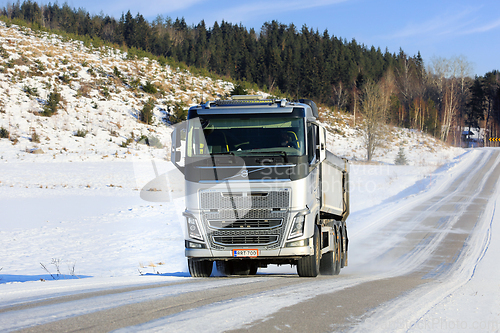 Image of Silver Volvo FH Gravel Truck on Rural Road in Winter