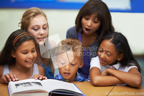 Image of School teacher, classroom and reading book with students, education and knowledge or learning. Female person, children and literature for english development, collaboration and unity at academy